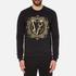 Men?s black sweatshirt from Versace Jeans. Crafted from pure cotton and cut for a regular fit, the sweater comprises a crew neckline, long sleeves and a straight hem, all boasting ribbed trims. The pullover is complete with the signature Versace Jeans tiger logo embroidered to the front in a metallic gold tone.  100% Cotton Model is 188cm/6'2  and wears a size M.