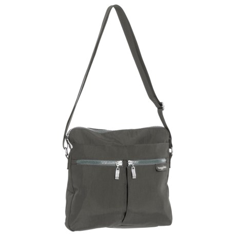 CLOSEOUTS . A friend you can rely on to keep your essentials within reach, baggalliniand#39;s Comrade crossbody bag boasts a plethora of pockets in light, water-resistant nylon for holding everything from a tube of lipstick to a paperback book. Available Colors: CHARCOAL, PEWTER FLORAL, BLACK/SAND LINING, ADOBE.